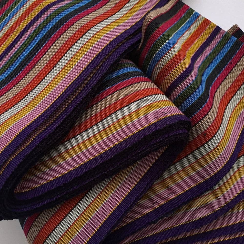 Folded woven fabric featuring a vibrant pattern of multi-colored stripes in various widths.