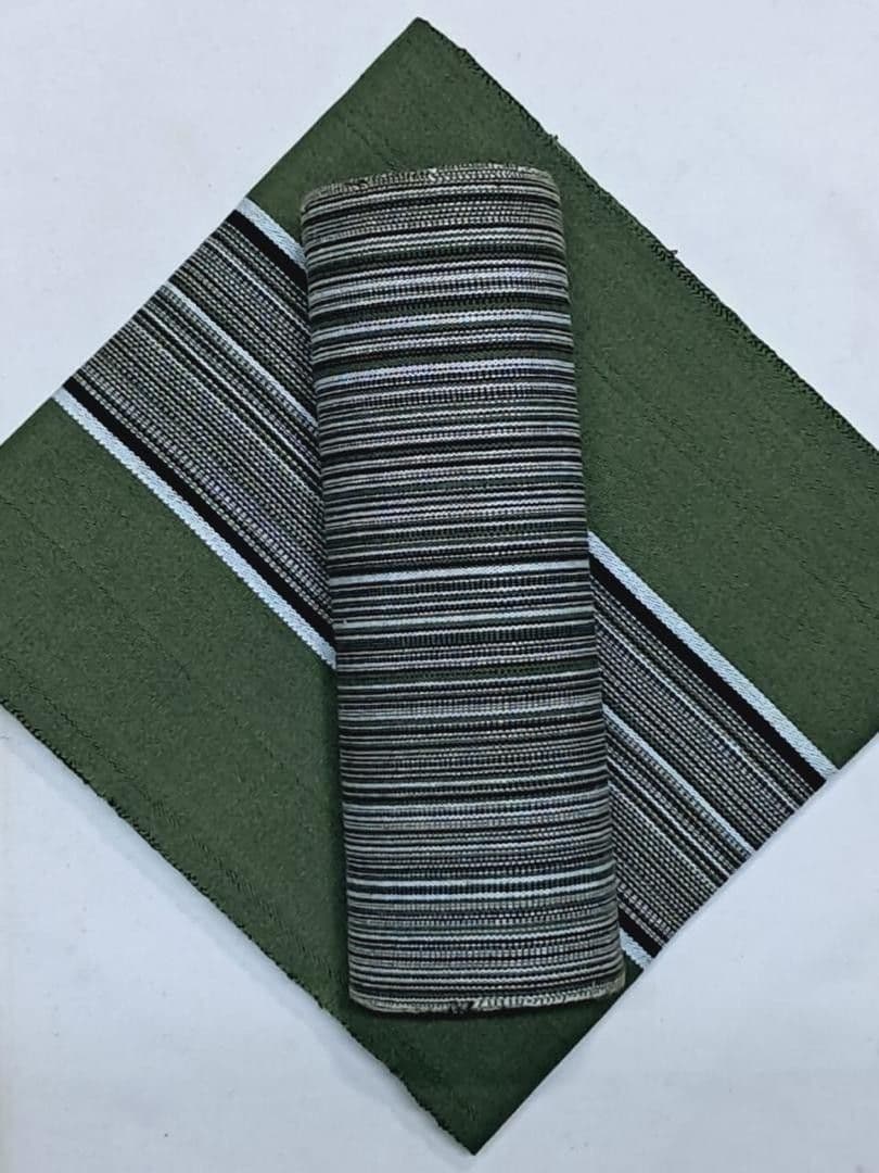 Olive green fabric with a black and white striped border and matching rolled-up striped textile.