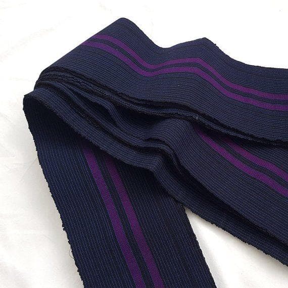 Navy blue ribbed elastic webbing with two purple stripes, folded on a white background.
